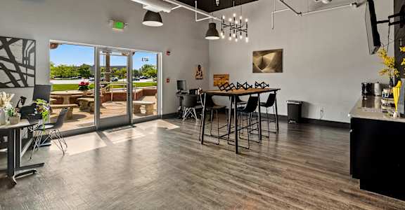 A modern kitchen with a dining table and chairs.