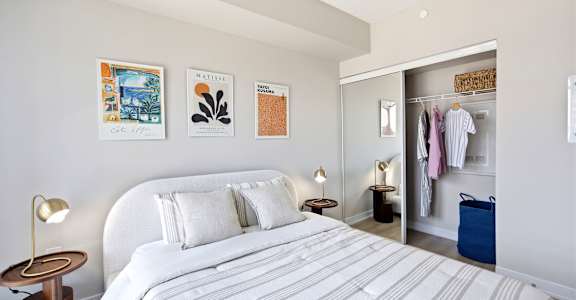 A bedroom with a large bed and a wardrobe.