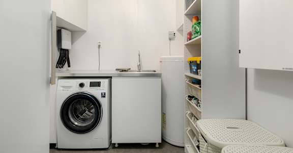 A small laundry room with a washer and dryer.