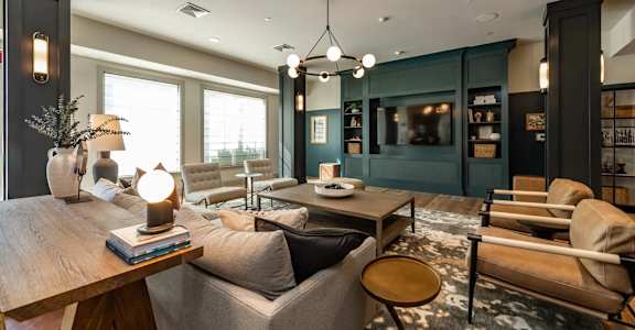 A modern living room with a wooden coffee table and grey sofa.