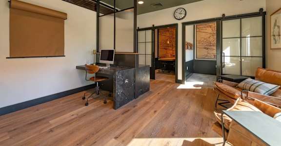 A room with a wooden floor and a glass wall.