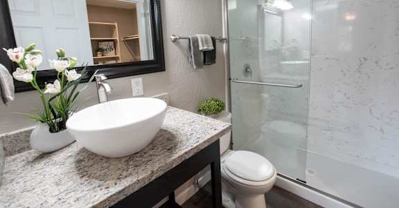bathroom with granite counters and shower