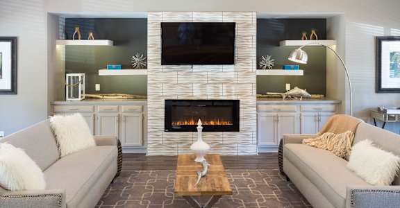 A living room with a fireplace and a television.