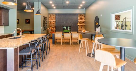 A restaurant with tables and chairs and a counter.