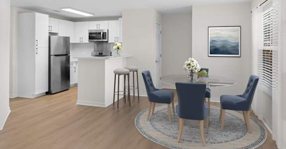 A modern kitchen with a dining table set for four. at Reflection Pointe, Flowood, MS