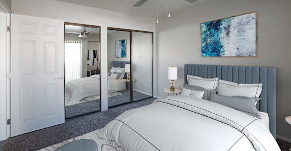 a white bedroom with a large bed and a ceiling fan