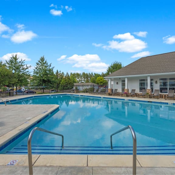 a swimming pool with a building in the background