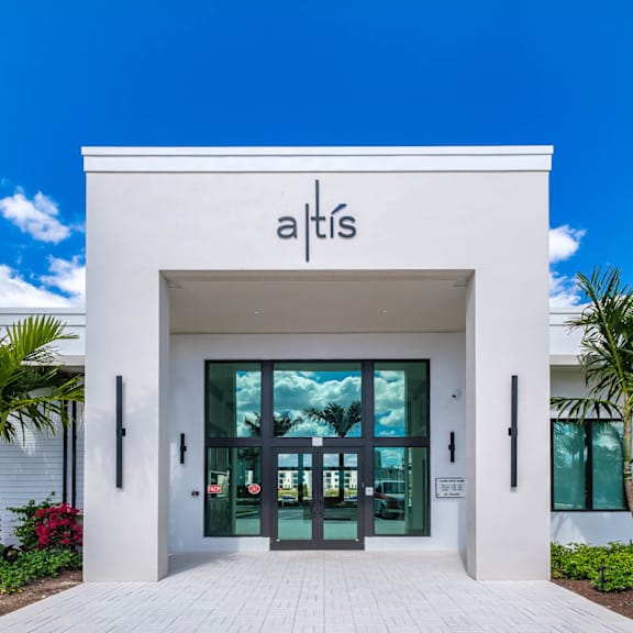 The front of a white building with the name "at's" on it.