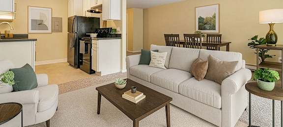 A living room with a white couch and a coffee table.