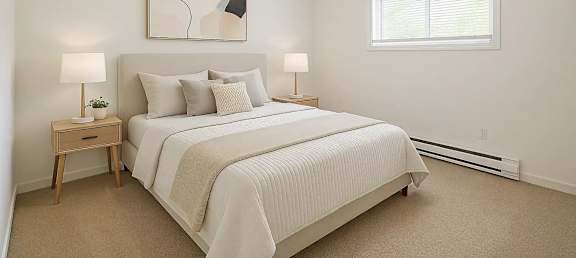 A bedroom with a large bed and a painting on the wall.