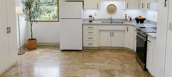 A kitchen with white appliances and cabinets.