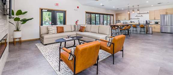 A modern living room with a large couch and a television.