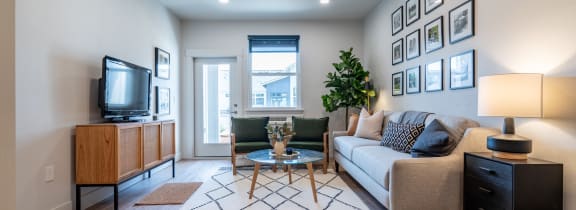 a living room with a couch and a tv at Sonder Fields in Happy Valley, OR