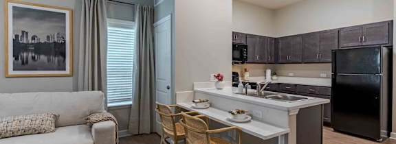 A modern kitchen with a dining table and chairs.