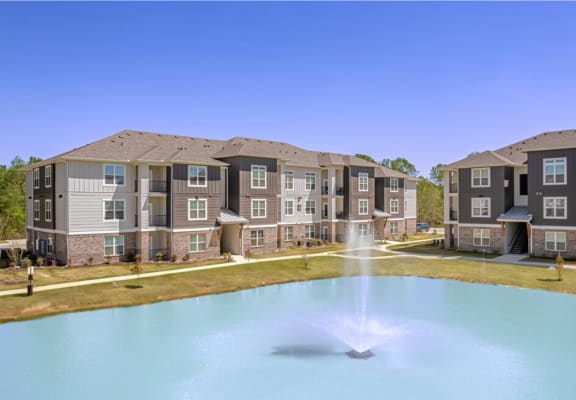 an image of an apartment building with a fountain