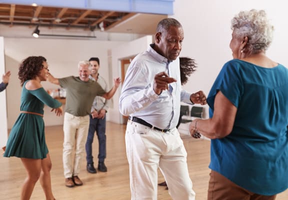 a group of people dancing in a dance studio