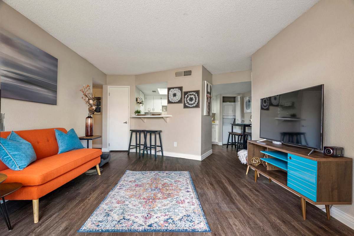 Furnished apartment living area shown — representative home at The Place at Wickertree.