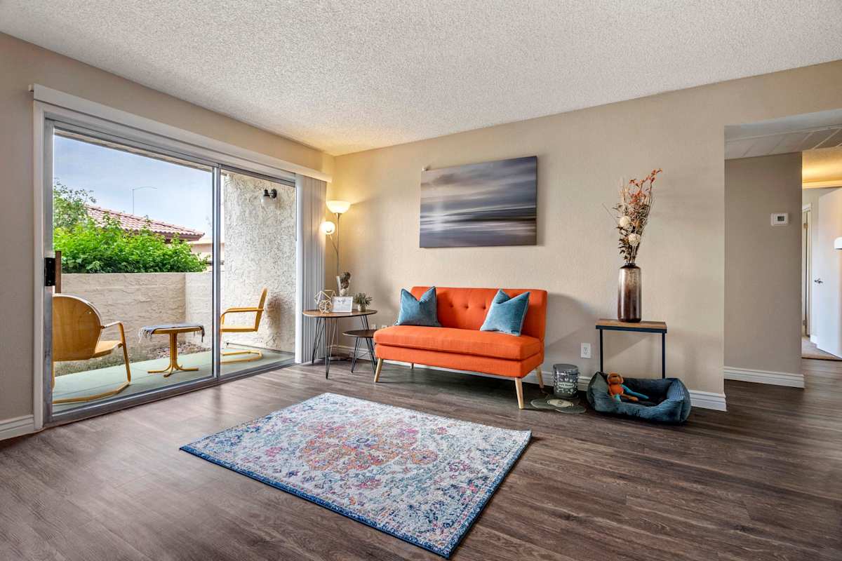 Furnished apartment living area shown — representative home at The Place at Wickertree.