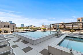 A large outdoor swimming pool area with multiple pools and lounging areas.