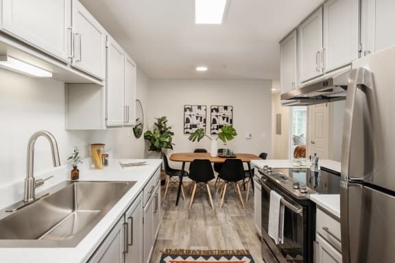 a kitchen and dining area in a 555 waverly unit
