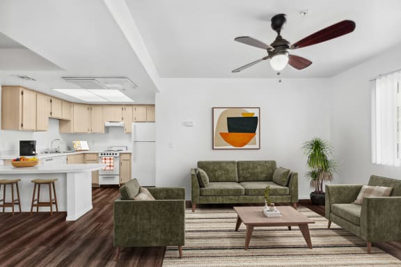a bedroom with white walls and a white ceiling fan