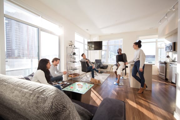 a group of people are gathered in a living room at Versus, Calgary, Alberta