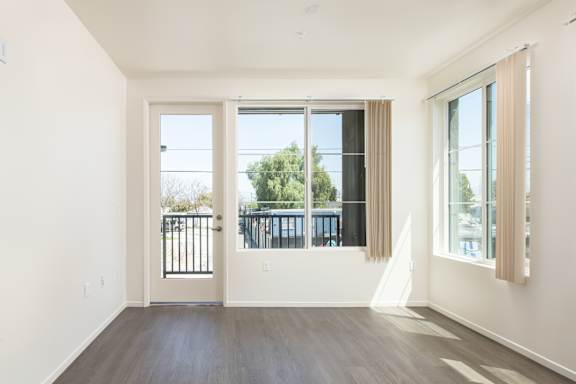 a living room with a large window and a balcony