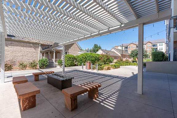 a covered patio with benches and a fire pit at City View St. George, St. George, Utah