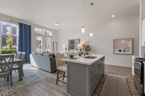 Modern kitchen with a grey island and wooden floors at 200 City View, Utah