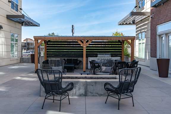 Patio with a table and chairs under a wooden pergola1 at 200 City View, Utah, 84601