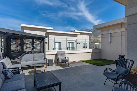 Modern patio with a table, chairs, and a couch at 200 City View, Provo, Utah