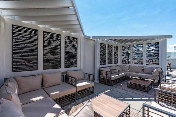 a patio with couches and tables on a roof 605 Place Student Housing & Co-Living, St George, UT 84770