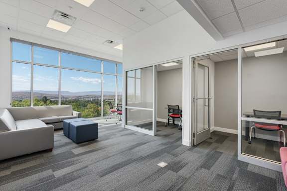 A spacious office room with a view of the cityscape outside the large windows. 605 Place Student Housing & Co-Living, St George