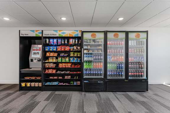 A vending machine with a variety of snacks and drinks. 605 Place Student Housing & Co-Living, St George Utah