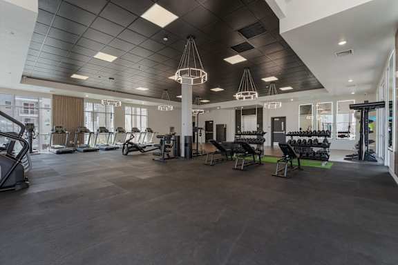 A gym with a variety of exercise equipment. 605 Place Student Housing & Co-Living, Utah