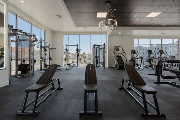 a gym with chest exercise equipment and large windows 605 Place Student Housing & Co-Living, St George, UT 84770