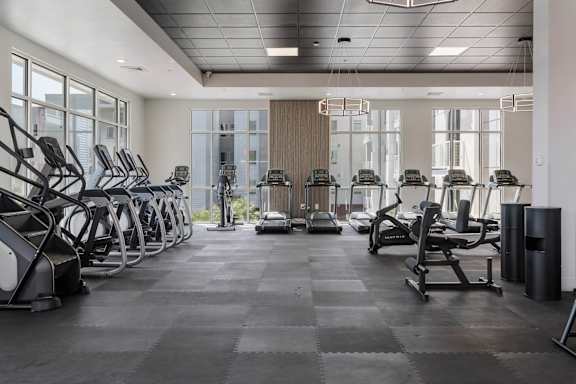 A gym with treadmills, elliptical machines and other cardio equipment. 605 Place Student Housing & Co-Living, St George