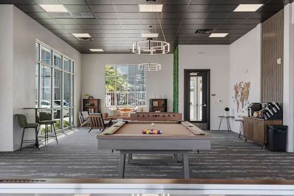 A room with a pool table and a shelf with various items. 605 Place Student Housing & Co-Living, St George, UT 84770