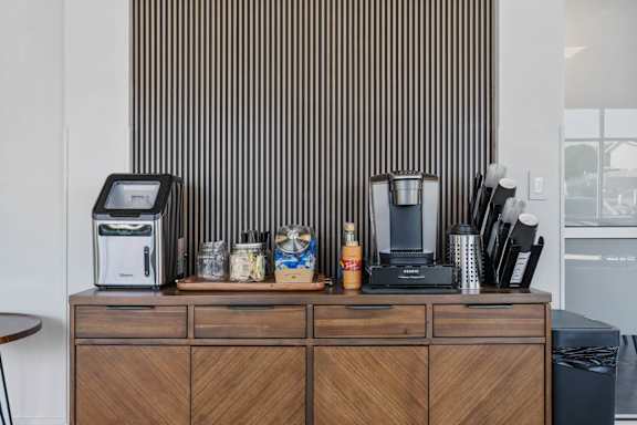 A coffee machine sits on a wooden cabinet with a digital display. 605 Place Student Housing & Co-Living, Utah