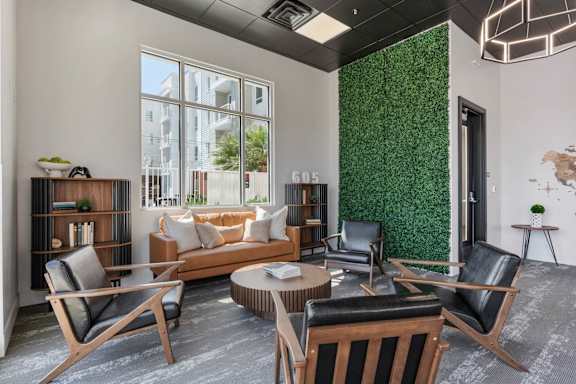 A living room with a green wall and a sofa. 605 Place Student Housing & Co-Living, St George