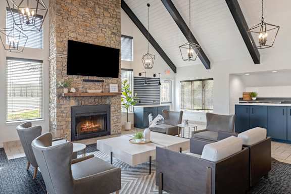 A modern living room with a stone fireplace and a flat screen TV mounted above it.