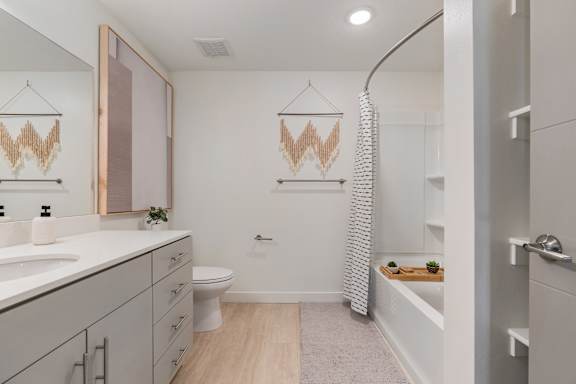 A bathroom with a toilet, sink, and a shower curtain.