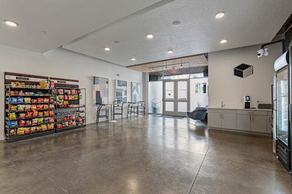 A room with a white ceiling and a wall of snacks.