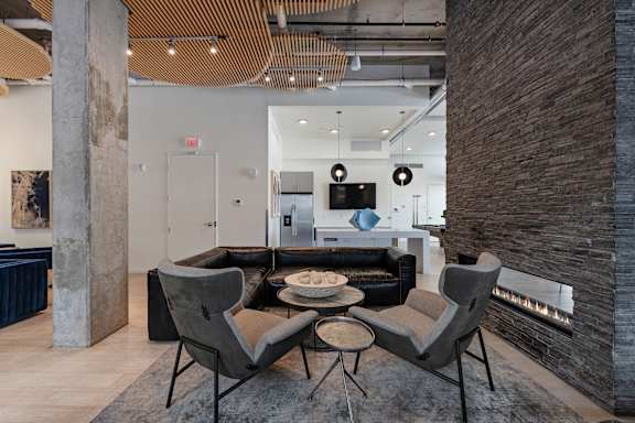 A modern living room with a fireplace and a large couch.