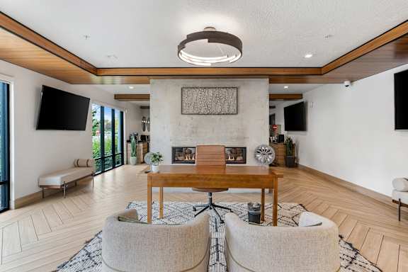 A modern living room with a wooden table and two chairs at The Flats at Riverwoods, Provo, UT, 84604
