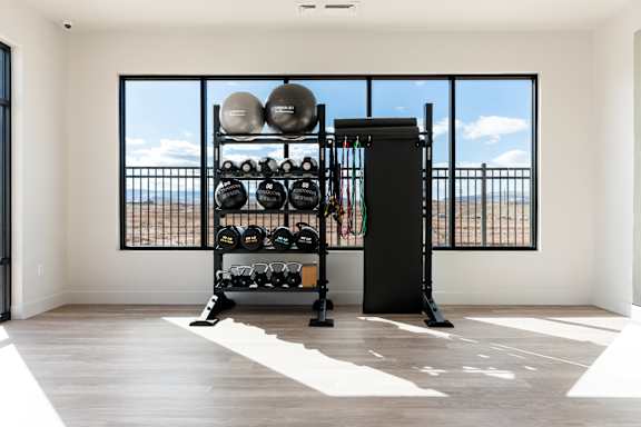 Black weight rack with weights and resistance bands at The Vue At Desert Color, St. George