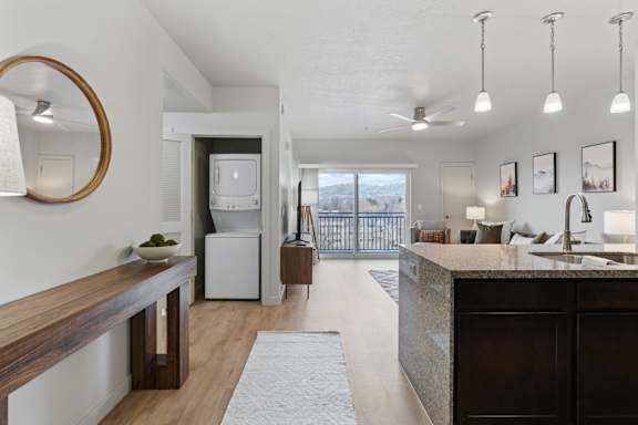 A modern kitchen with a large island and a view of the outdoors.