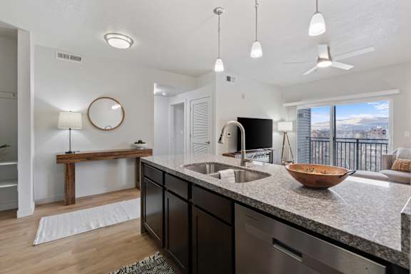 A modern kitchen with a large island and a view of the mountains.