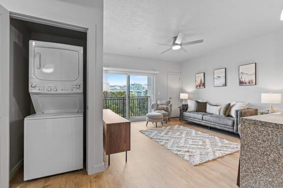 A modern living room with a television and a balcony overlooking the city.