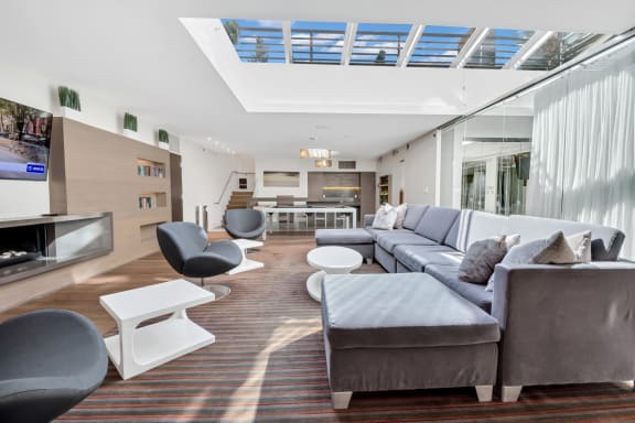 a living room with couches and chairs and a television